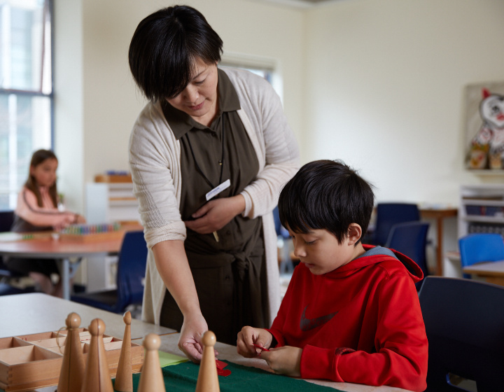 teacher helping a student